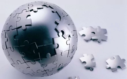 CGI 3D metallic sphere made of interlocking puzzle pieces, with several loose pieces nearby, rendered in high definition for a PC desktop wallpaper.