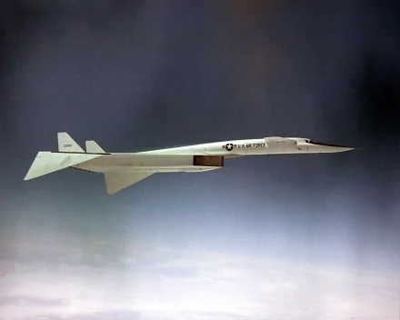 HD desktop wallpaper showing a North American XB-70 Valkyrie military supersonic prototype flying above clouds, long slender fuselage and twin vertical tails.