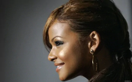 Close-up profile of Christina Milian smiling against a dark background, captured in HD for a music-themed PC desktop wallpaper.