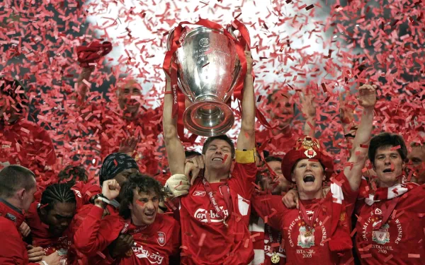 Celebrating Liverpool F.C.'s victory, players are surrounded by confetti as they lift the trophy, capturing the essence of sports triumph in this HD desktop wallpaper.
