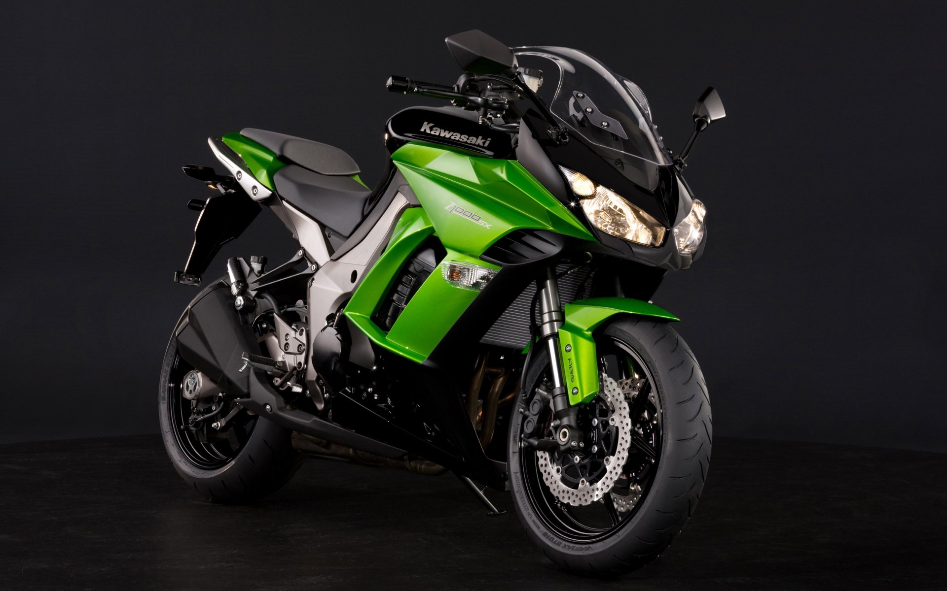 Green Kawasaki Z1000SX sport-touring motorcycle on a black backdrop — 2K Quad HD PC desktop wallpaper/background.