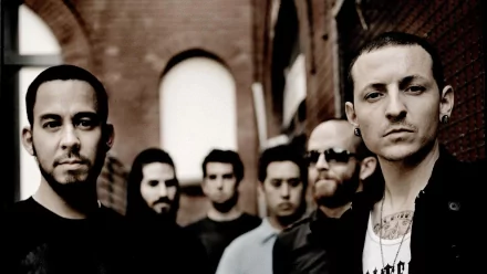 A high-definition desktop wallpaper featuring the band Linkin Park, showcasing the group in a moody, urban setting. The image captures their distinctive style and energy.