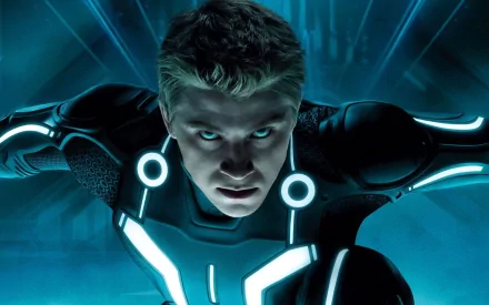 HD PC desktop wallpaper background from the movie TRON: Legacy: a determined figure in a glowing blue neon suit lunging forward against a dark digital grid.