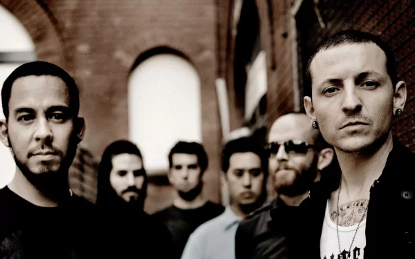 A high-definition desktop wallpaper featuring the band Linkin Park, showcasing the group in a moody, urban setting. The image captures their distinctive style and energy.