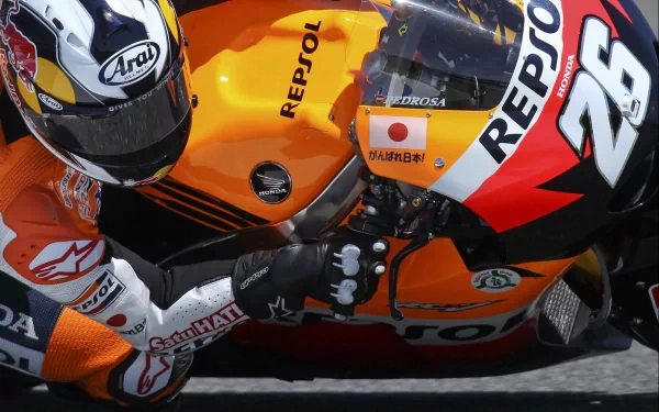 HD desktop wallpaper featuring a close-up of a Honda Repsol racing motorcycle and rider in full gear during a race.
