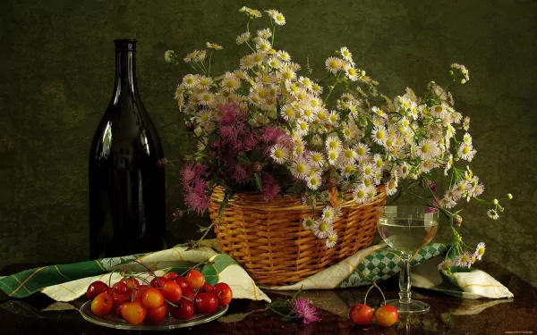 HD PC desktop wallpaper featuring a still life of a basket with wildflowers, a dark wine bottle, a glass, and fresh cherries on a green cloth.