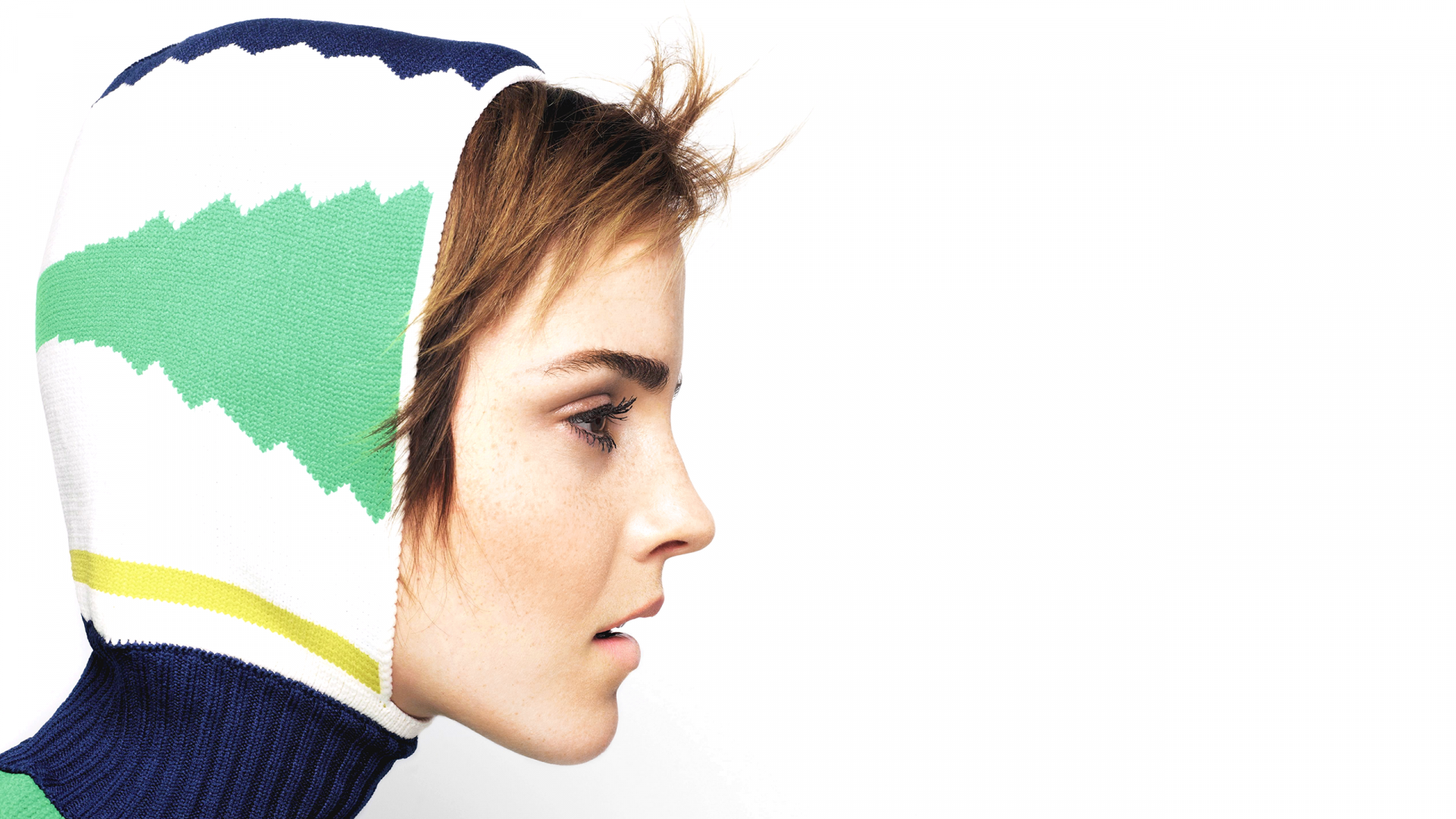 HD PC desktop wallpaper featuring a close-up profile of celebrity Emma Watson wearing a colorful hood against a white background.
