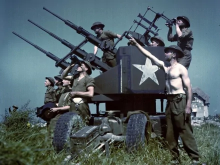HD military-themed PC desktop wallpaper showing soldiers manning mounted anti-aircraft guns in a field under a clear sky.