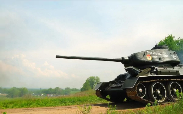 HD PC desktop wallpaper featuring a military T-34 tank positioned on a grassy field under a clear sky.