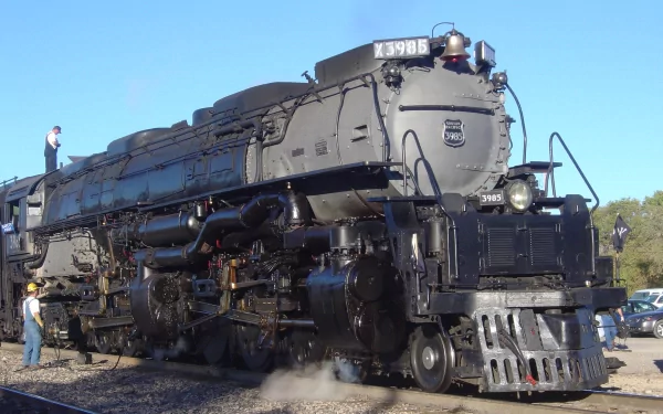HD desktop wallpaper of a majestic vintage train. The image features detailed components, highlighted by the clear, high-definition quality. A cloudy sky provides a dramatic backdrop for the powerful locomotive.