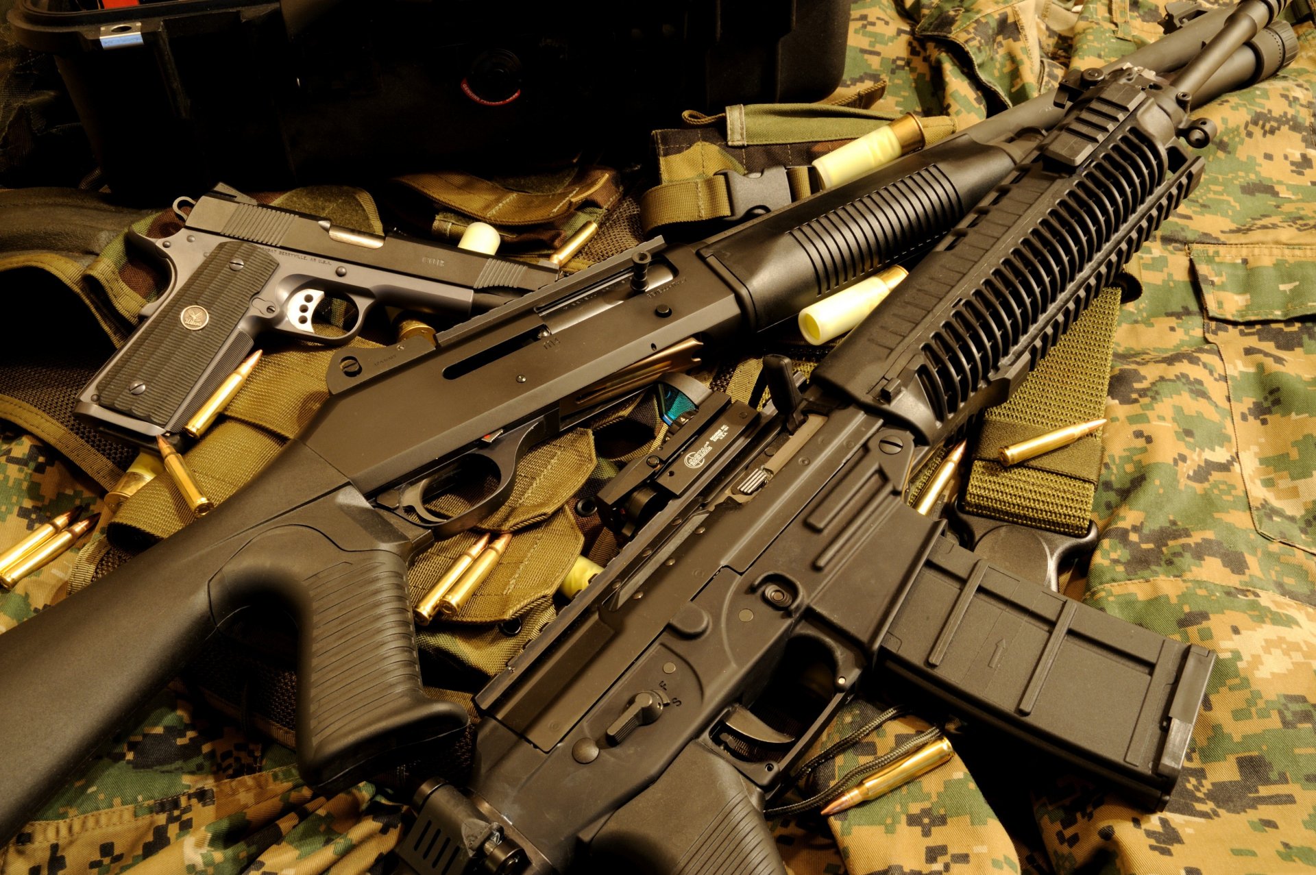 HD desktop wallpaper featuring a close-up of man-made assault rifles resting on military gear with a camouflage background.