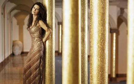 HD PC desktop wallpaper featuring Shania Twain in a shimmering gold dress, leaning against ornate golden columns in an elegant architectural setting.