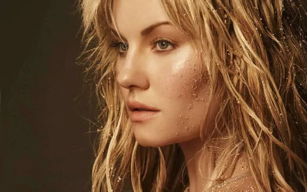 A stunning HD wallpaper featuring Elisha Cuthbert with wet, tousled hair, showcasing her natural beauty and captivating expression against a warm background.