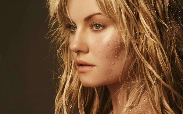 A stunning HD wallpaper featuring Elisha Cuthbert with wet, tousled hair, showcasing her natural beauty and captivating expression against a warm background.