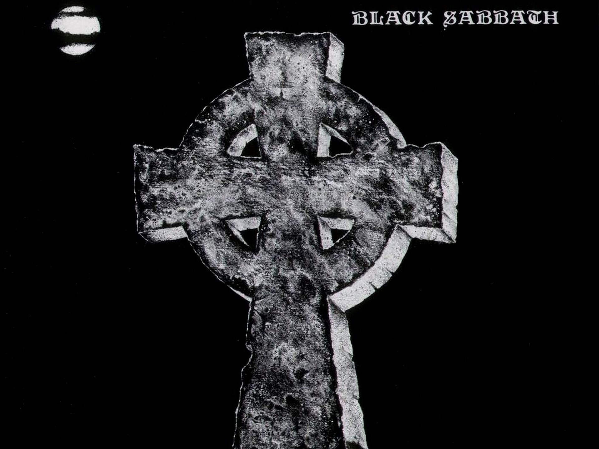 HD desktop wallpaper featuring a weathered stone Celtic cross against a black background, inspired by Black Sabbath's iconic dark and heavy music themes.