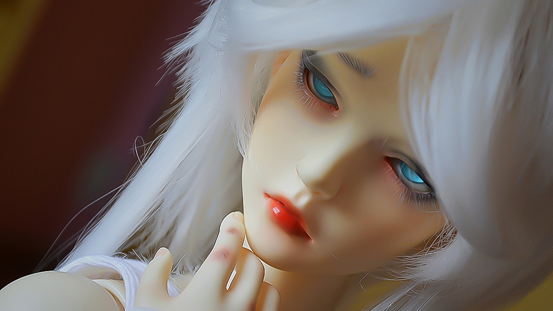 Artistic HD PC desktop wallpaper featuring a close-up of a woman with pale skin, striking blue eyes, and long white hair.