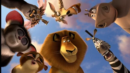 HD PC desktop wallpaper featuring main characters from the movie Madagascar 3: Europe’s Most Wanted looking down against a blue sky background.