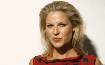 HD desktop wallpaper featuring celebrity Ali Larter with blonde hair wearing a red and black patterned top against a neutral background.