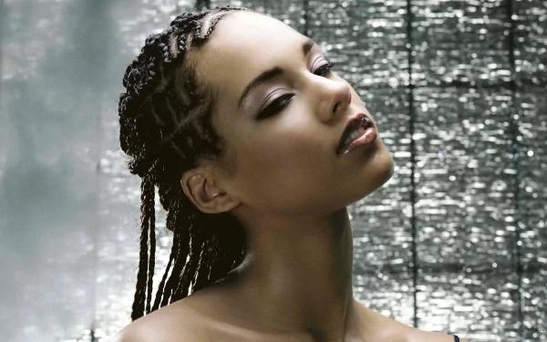 HD PC desktop wallpaper featuring a close-up portrait of Alicia Keys with braided hair and a reflective silver background, highlighting her serene expression.