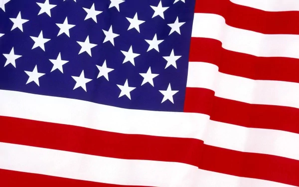 HD desktop wallpaper featuring a close-up of the American flag with its stars and stripes in vibrant red, white, and blue colors.
