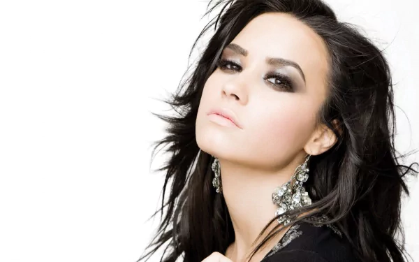HD desktop wallpaper featuring Demi Lovato with smoky eye makeup and statement earrings, reflecting her music persona.