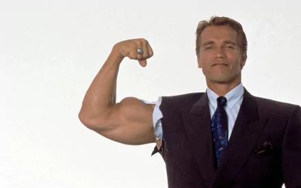 Arnold Schwarzenegger flexes his bicep in a suit, showcasing strength and charisma. This HD wallpaper features the iconic celebrity in a striking pose against a neutral background.