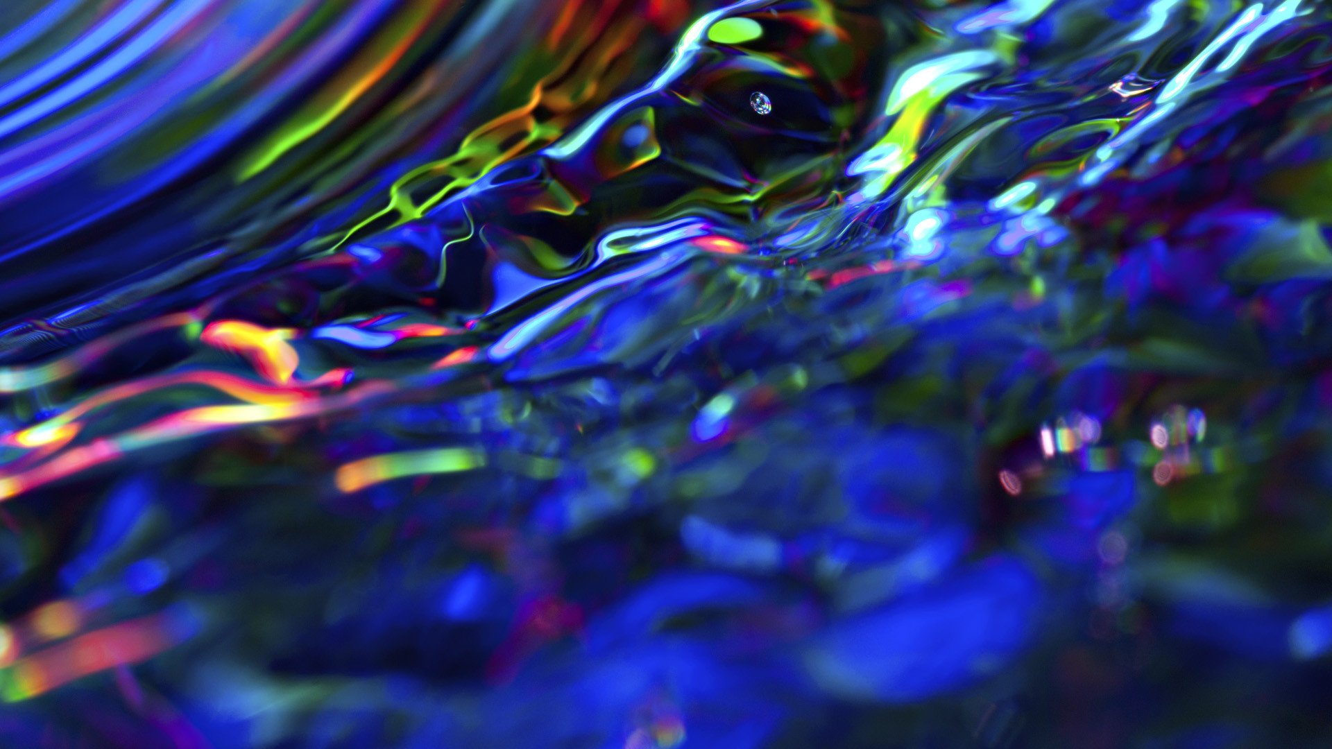 Abstract artistic HD PC desktop wallpaper and background showing iridescent blue and neon ripples flowing like liquid glass.