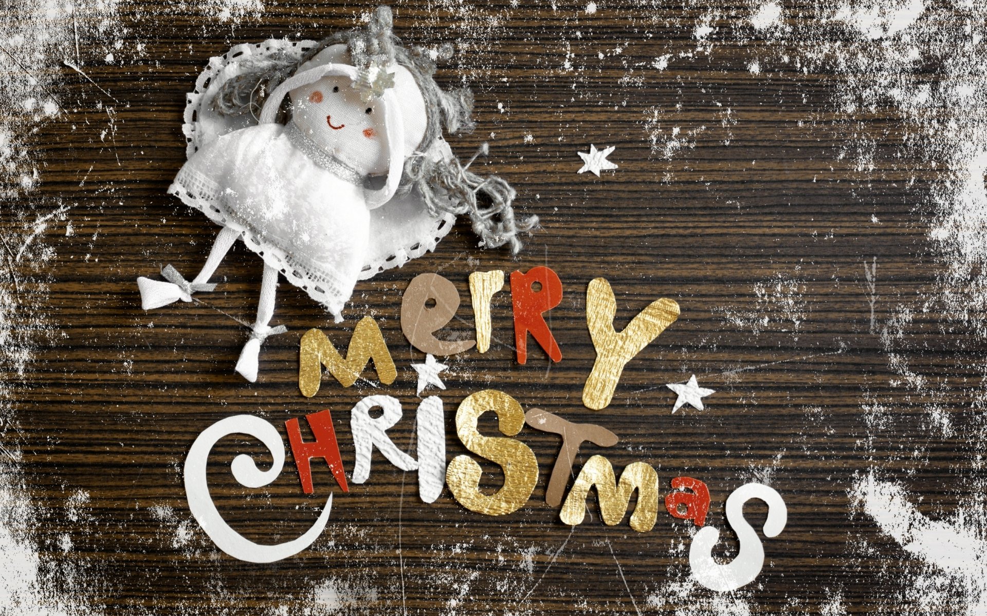 Merry Christmas holiday 2K Quad HD PC desktop wallpaper: rustic wood dusted with snow, a stitched pillow snowman and colorful hand-cut letters reading Merry Christmas.