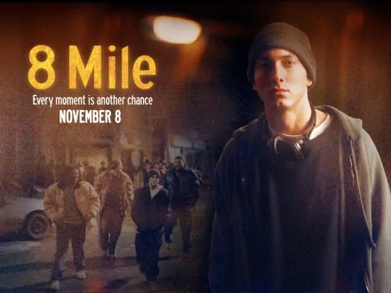 HD PC desktop wallpaper: 8 Mile movie drama poster showing a young man in a hoodie and headphones standing on a gritty urban street, with the film title and release date overlaid.