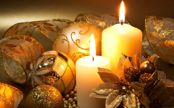 HD desktop wallpaper featuring lit candles surrounded by elegant Christmas ornaments and festive decorations, exuding a warm holiday ambiance.