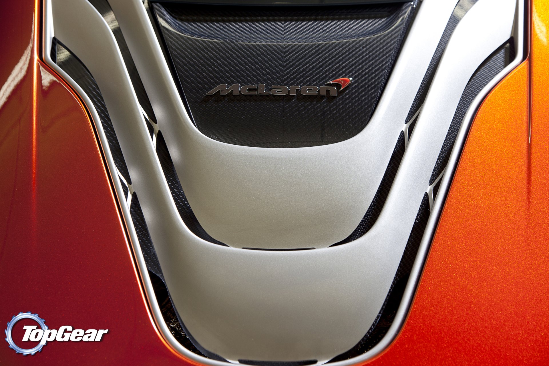 HD PC desktop wallpaper/background of a McLaren vehicle: close-up of the glossy orange rear engine cover showcasing the McLaren logo and TopGear badge.