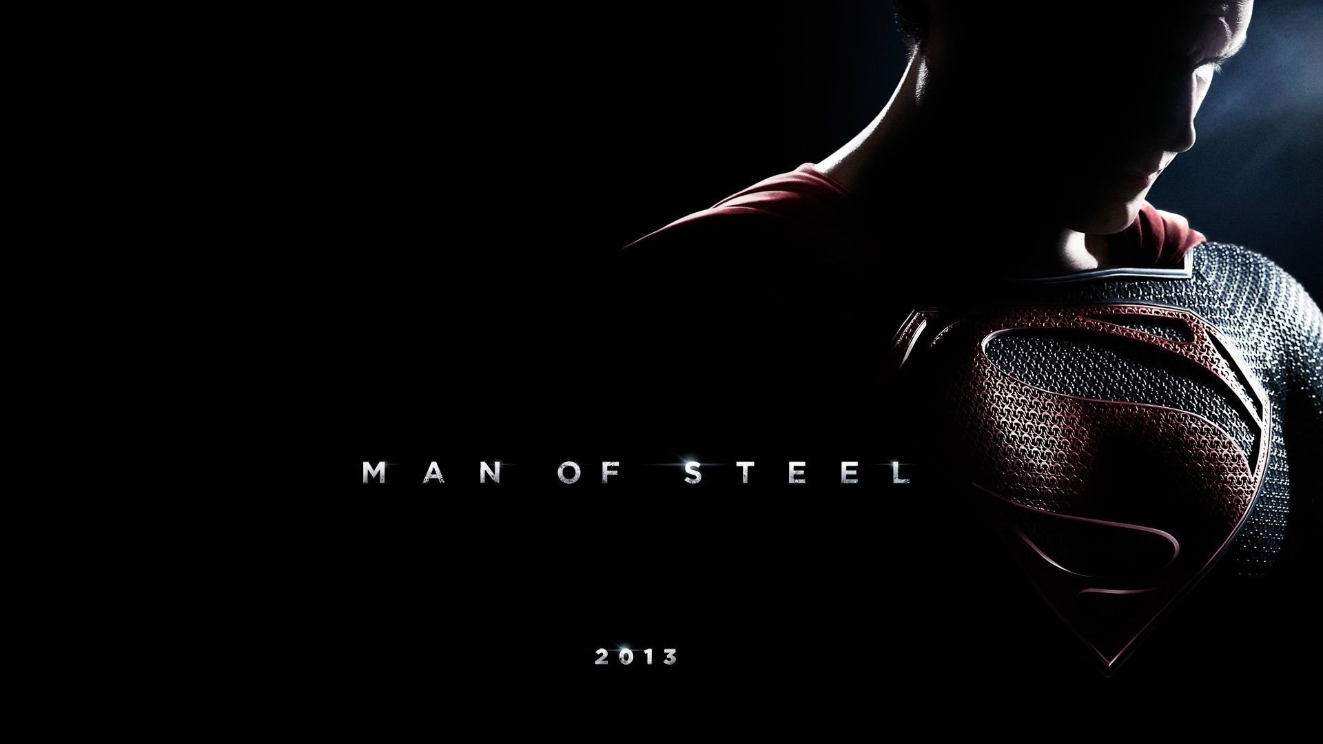 A dramatic HD wallpaper featuring Superman's silhouette and the title Man of Steel, showcasing the iconic character from the 2013 movie against a dark background.