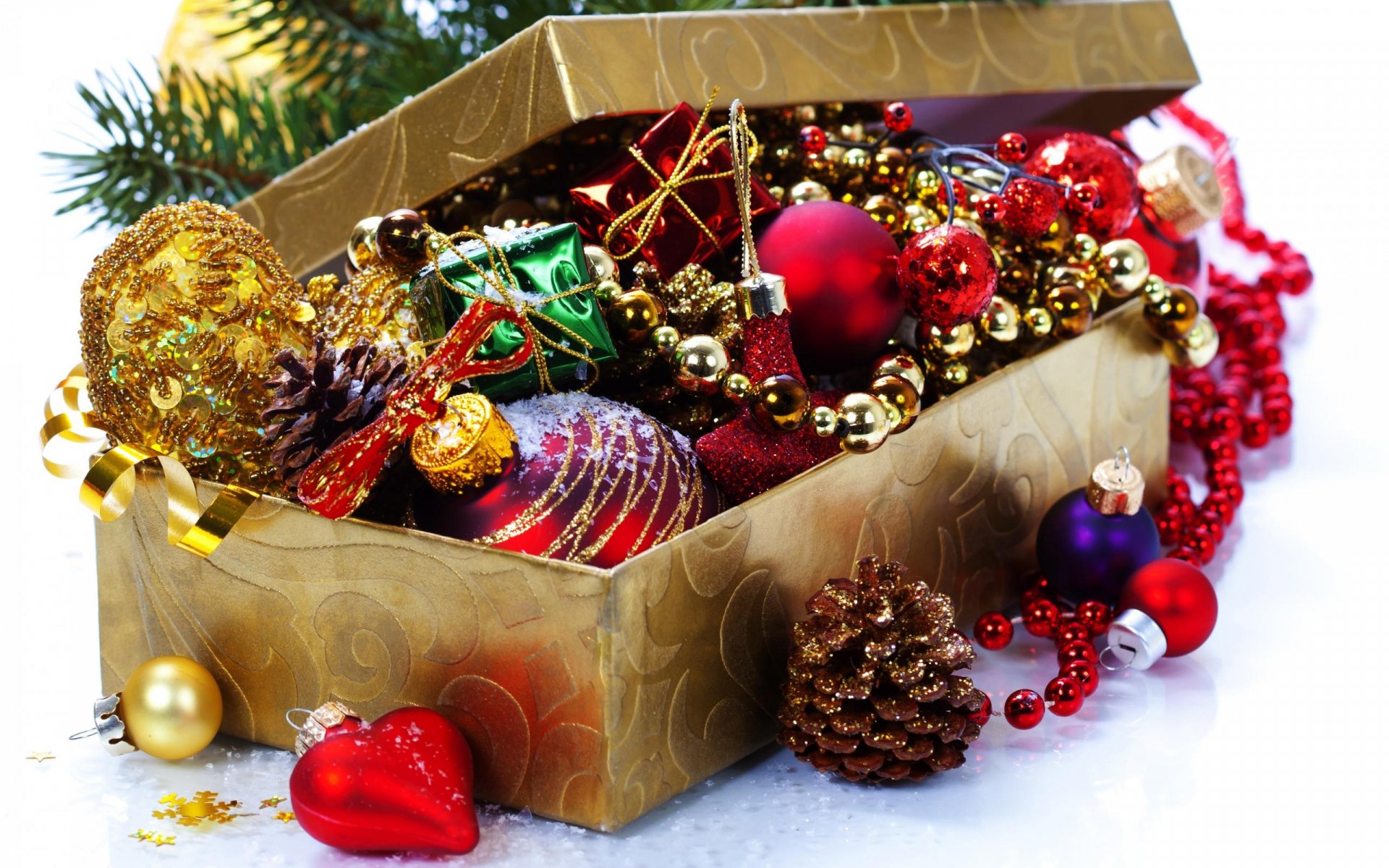 A festive box overflowing with colorful Christmas ornaments, including shiny baubles and garlands, set against a backdrop of holiday cheer. Perfect HD wallpaper for the holiday season.