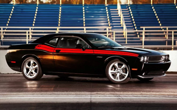 Black Dodge Challenger with red racing stripes showcased on a racetrack, captured as an HD PC desktop wallpaper background.