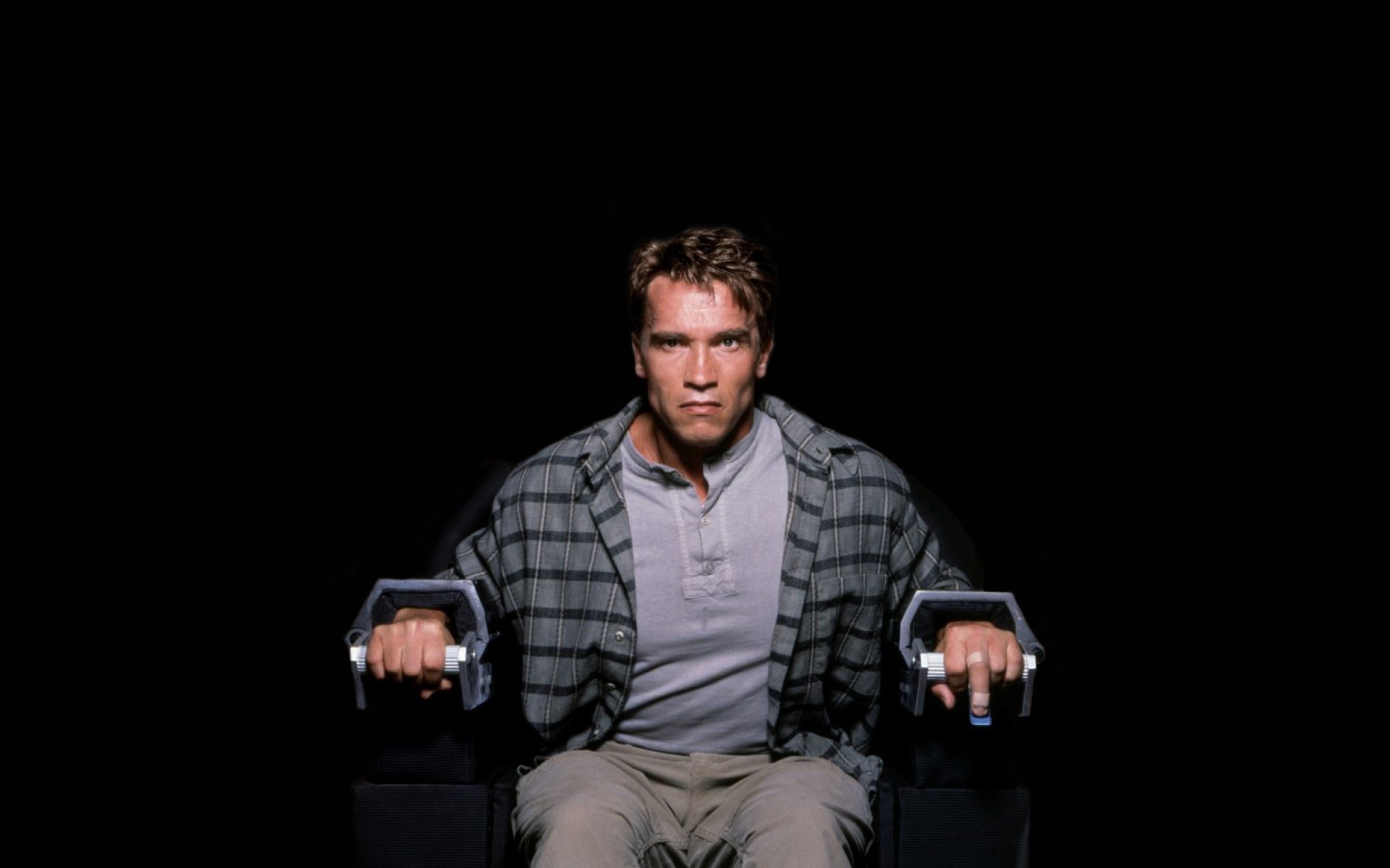 HD desktop wallpaper featuring celebrity Arnold Schwarzenegger in a focused pose, set against a black background.