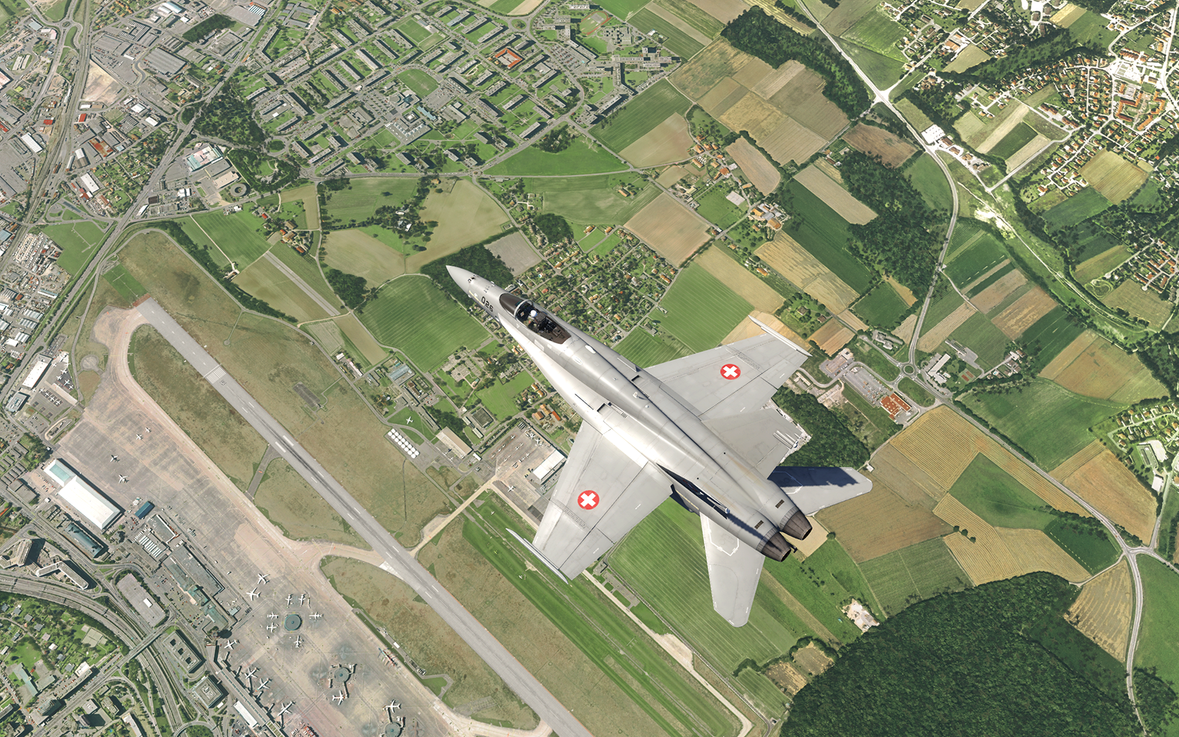 HD desktop wallpaper from Aerofly FS featuring a fighter jet flying over a realistic landscape with detailed urban and rural areas.