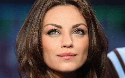 HD PC desktop wallpaper featuring a close-up portrait of celebrity Mila Kunis with a softly blurred background.