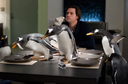 HD desktop wallpaper featuring Jim Carrey from the movie Mr. Popper's Penguins, surrounded by penguins gathered around a dining table.
