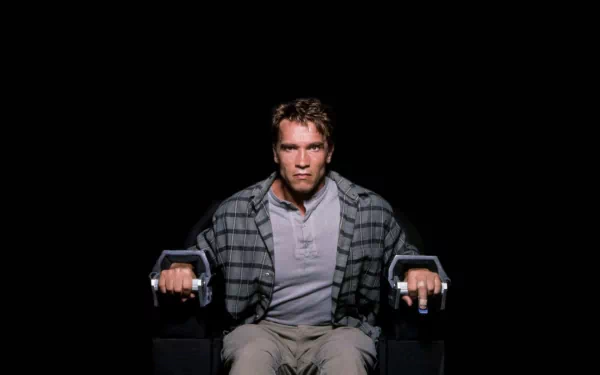 HD desktop wallpaper featuring celebrity Arnold Schwarzenegger in a focused pose, set against a black background.