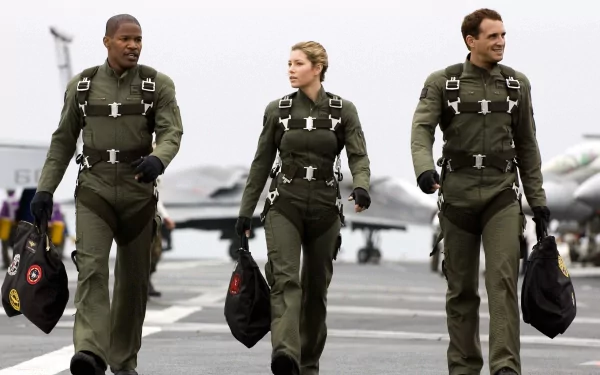 HD PC desktop wallpaper from the movie Stealth, featuring three pilots walking confidently on an aircraft carrier deck in flight suits.