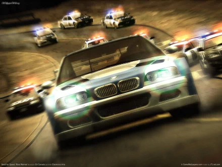 An intense scene from Need For Speed: Most Wanted, featuring a speeding blue BMW pursued by police cars, creating a thrilling atmosphere in this HD desktop wallpaper.