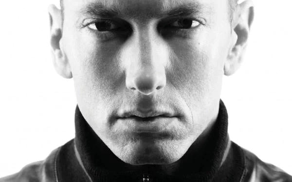 Black and white HD desktop wallpaper featuring Eminem in a serious expression. The image highlights the music icon's intense gaze.