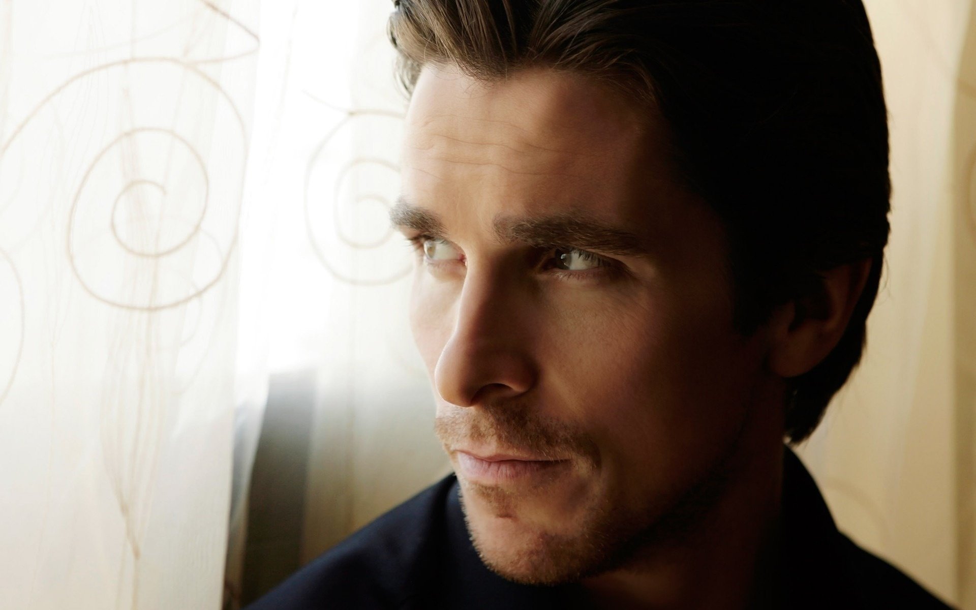 HD PC desktop wallpaper of celebrity Christian Bale, featuring a close-up portrait with soft lighting and a contemplative expression.