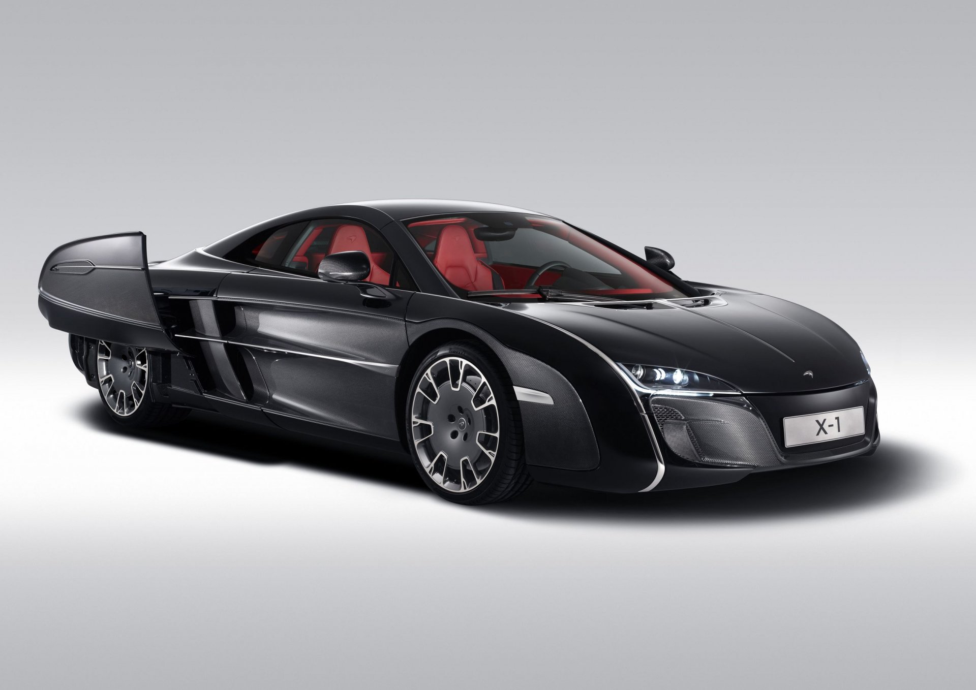 Black McLaren concept car with sleek futuristic design and red interior, showcased as an HD PC desktop wallpaper and background.