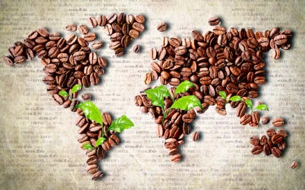 A creative desktop wallpaper featuring a world map crafted from coffee beans, complemented by green coffee plant leaves, set against a textured background.