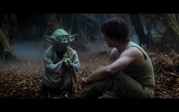 HD desktop wallpaper of Yoda and Luke Skywalker from Star Wars Episode V: The Empire Strikes Back, set in a misty forest.