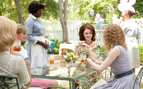 HD wallpaper from The Help featuring Jessica Chastain and Bryce Dallas Howard at an outdoor social gathering.