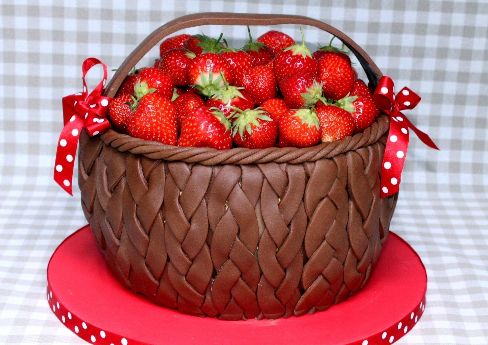 HD PC desktop wallpaper featuring a basket filled with fresh strawberries on a red surface, highlighting vibrant food imagery with a checkered background.
