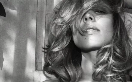 Black and white HD desktop wallpaper featuring a close-up portrait of celebrity Rachel McAdams with tousled hair partially covering her face.