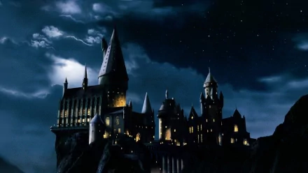 HD wallpaper of Hogwarts Castle at night from Harry Potter and the Philosopher's Stone with a lightning-streaked sky.